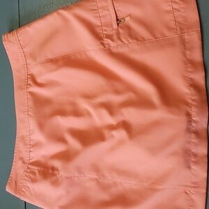 IZOD, ladies coral skort. Size 8 X-tra dry. 1 Zipper pocket. 100% polyester golf